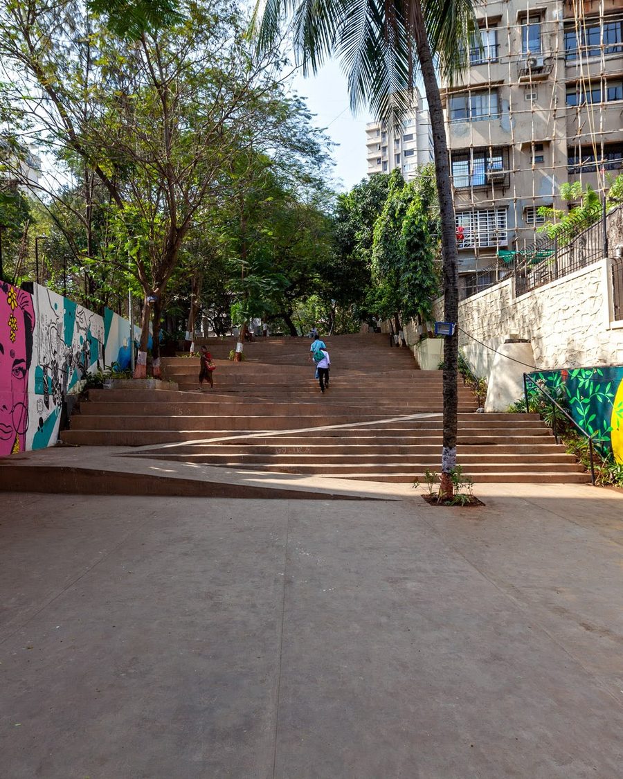 The Steps by day, with murals along the walls under the trees