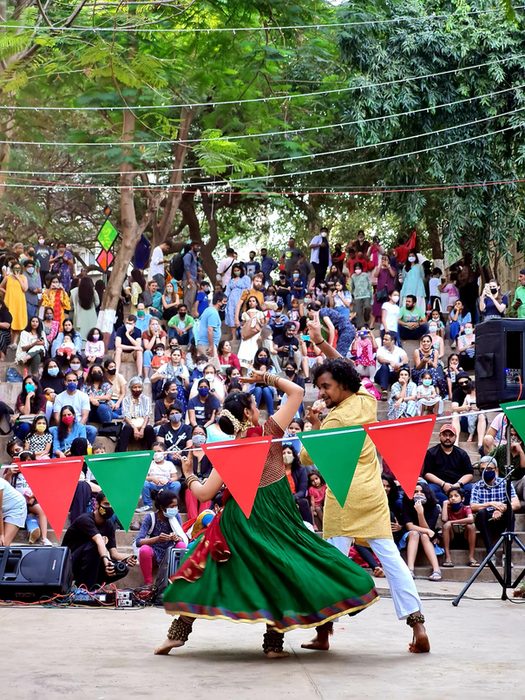 Dancers and a packed crowd under festival bunting